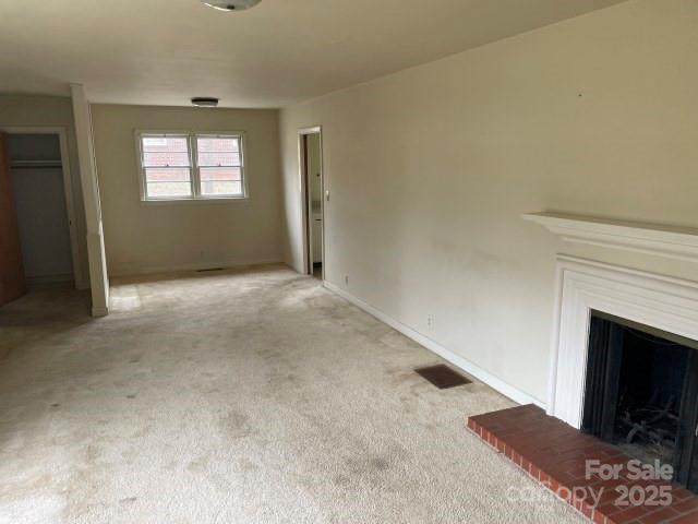 unfurnished living room with light carpet