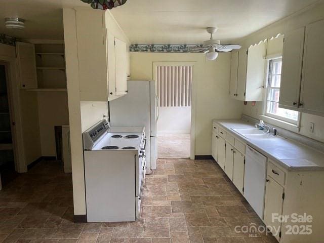 kitchen featuring ceiling fan, sink, white cabinets, and white appliances