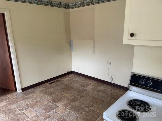 kitchen with white cabinetry and washer / clothes dryer