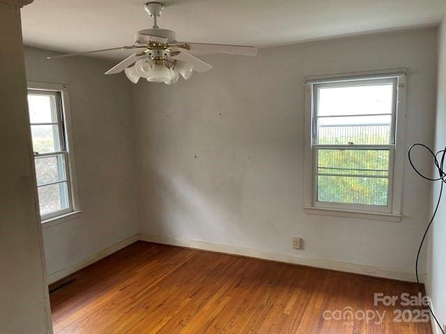 unfurnished room featuring light hardwood / wood-style floors, ceiling fan, and a healthy amount of sunlight