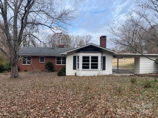 back of property featuring a carport