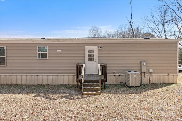 rear view of house featuring entry steps and cooling unit