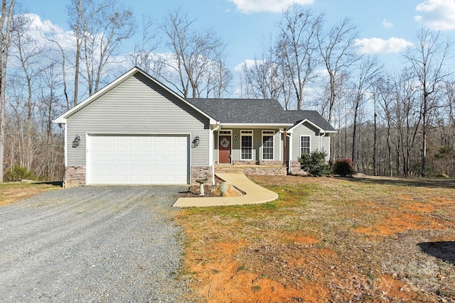 ranch-style home with a front lawn, a porch, and a garage