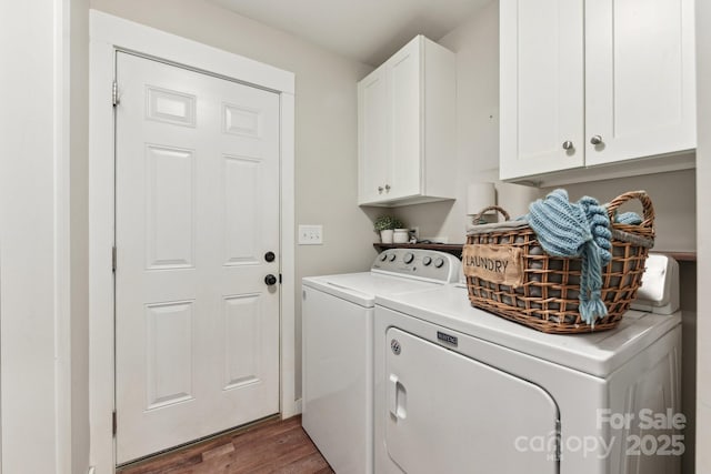 laundry room with washer and clothes dryer, dark wood-type flooring, and cabinets