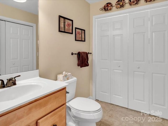 bathroom featuring tile patterned floors, vanity, and toilet