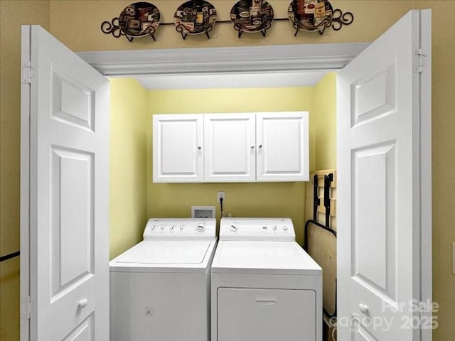 washroom featuring cabinets and washing machine and dryer