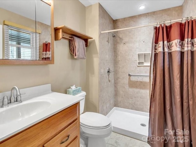 bathroom featuring a shower with shower curtain, vanity, and toilet