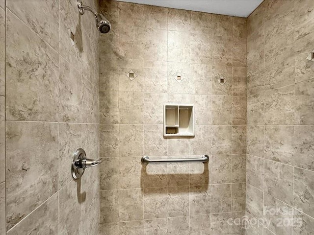 bathroom with tiled shower