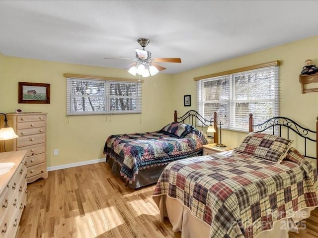 bedroom with light hardwood / wood-style floors and ceiling fan