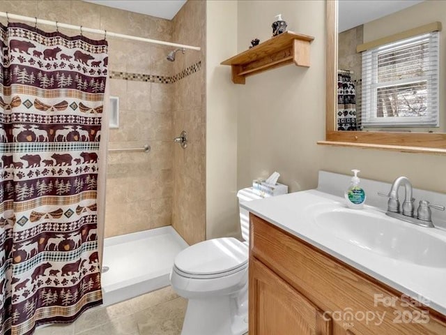 bathroom with a shower with curtain, vanity, toilet, and tile patterned floors