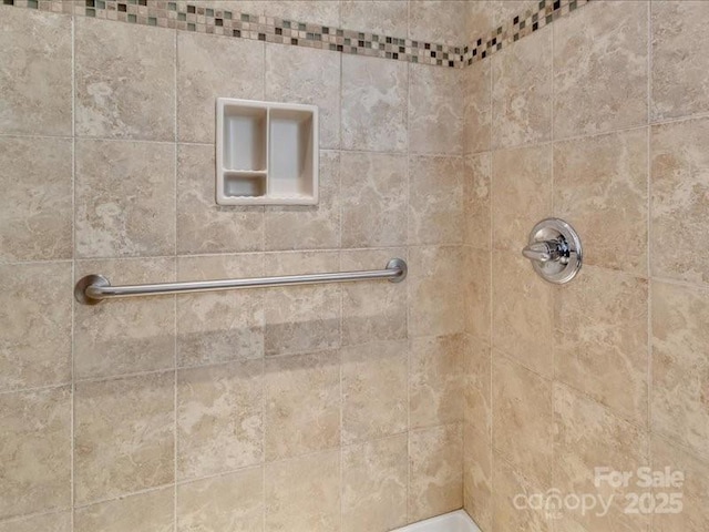 bathroom with a tile shower