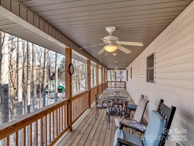 snow covered deck featuring a porch and ceiling fan