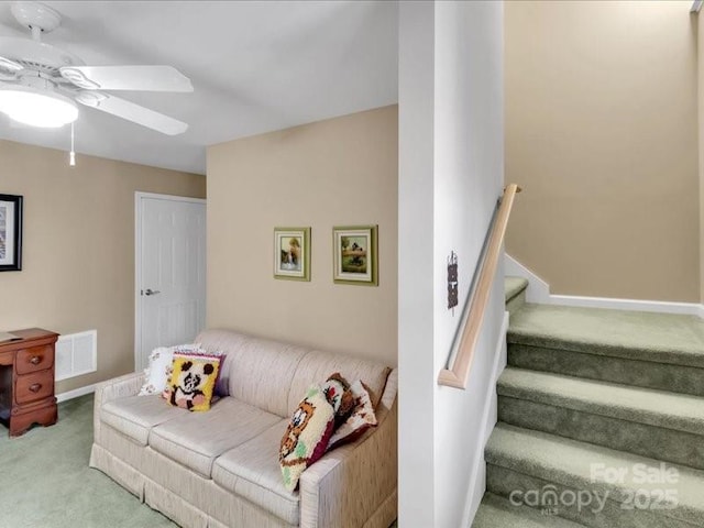 carpeted living room featuring ceiling fan