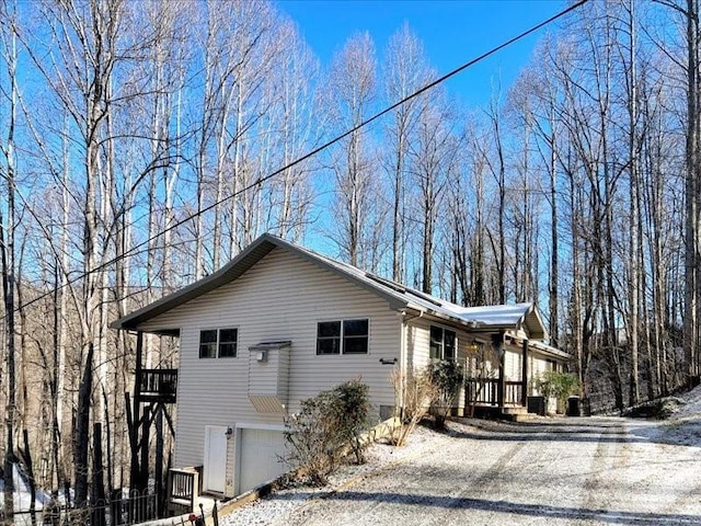 view of snowy exterior with a garage