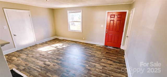 foyer featuring a textured ceiling, crown molding, and dark hardwood / wood-style flooring