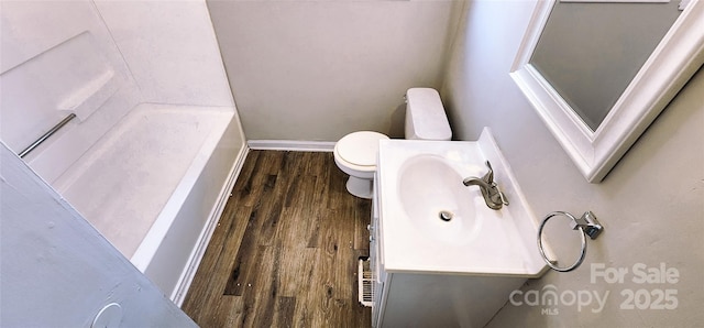 bathroom featuring toilet, hardwood / wood-style flooring, and vanity