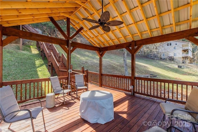 wooden deck with ceiling fan and a grill