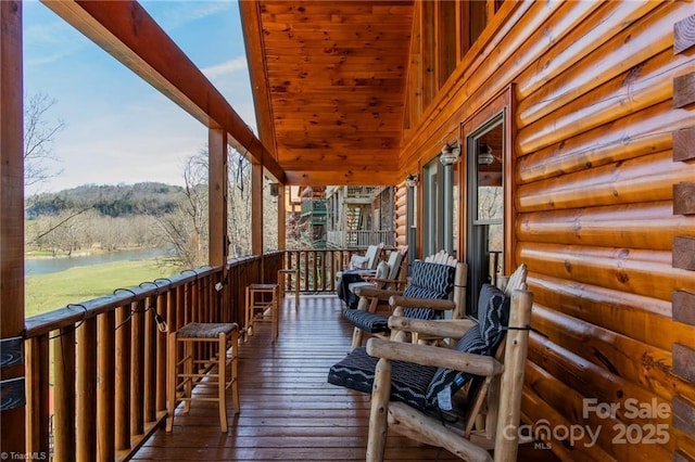 wooden terrace with a water view