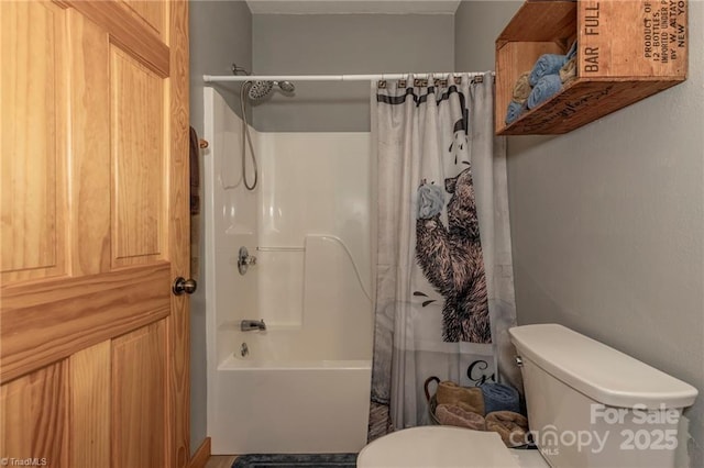 bathroom featuring shower / bath combination with curtain and toilet