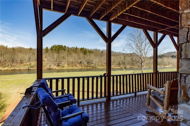 wooden deck featuring a yard and a water view