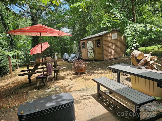 exterior space with a shed and a patio area