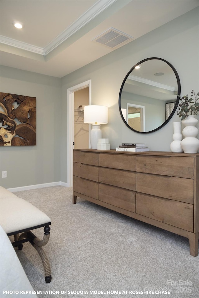 carpeted bedroom featuring a walk in closet, crown molding, and a tray ceiling