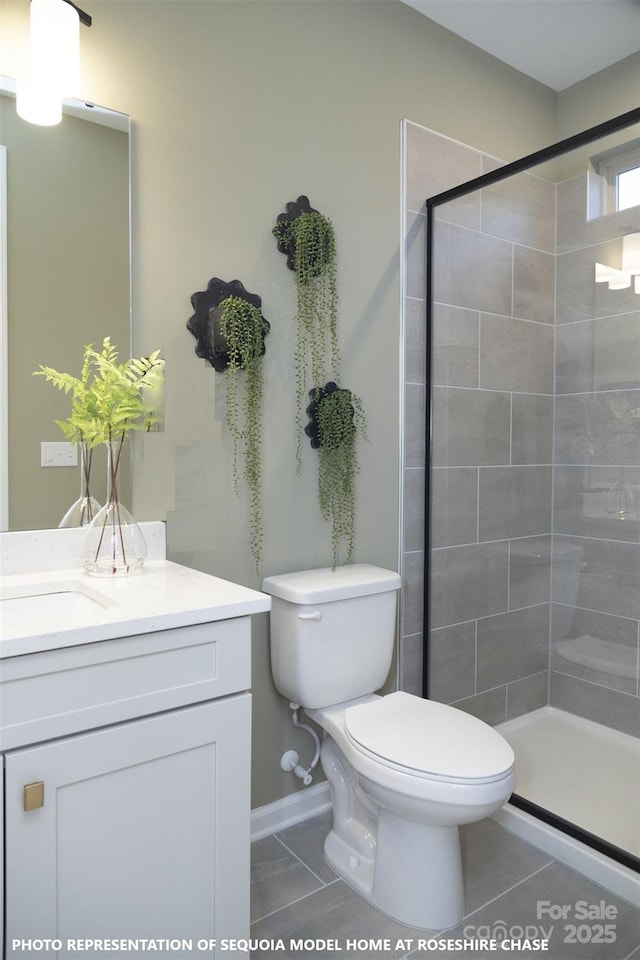 full bath featuring a stall shower, vanity, toilet, and tile patterned floors