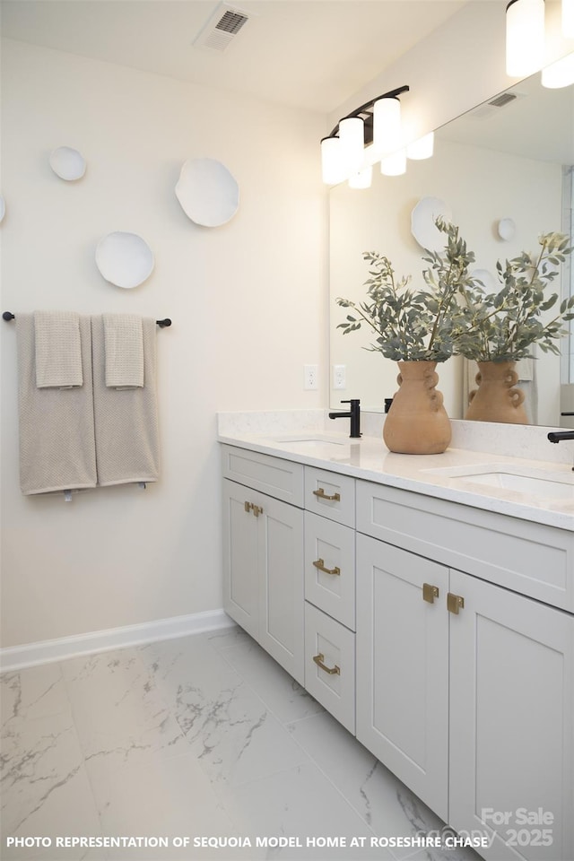 bathroom with marble finish floor, double vanity, a sink, and visible vents