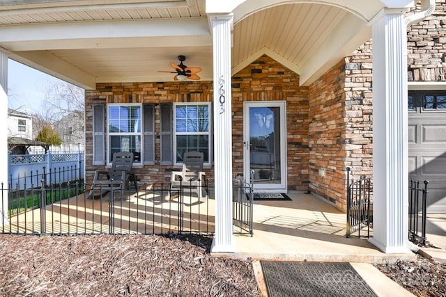 entrance to property featuring ceiling fan and covered porch