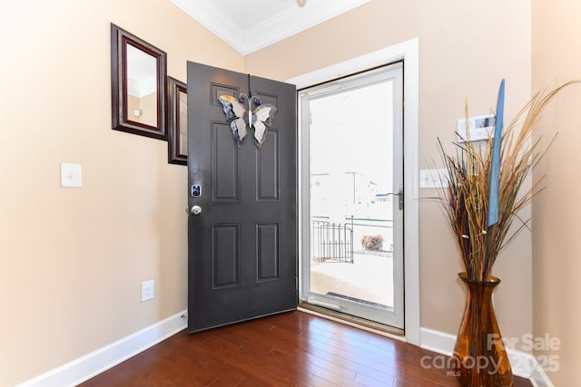 foyer entrance with dark hardwood / wood-style floors and ornamental molding