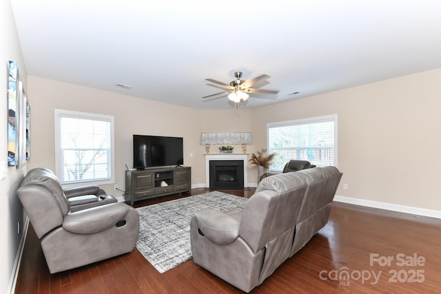 living room with ceiling fan and dark hardwood / wood-style flooring