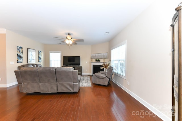 living room featuring dark hardwood / wood-style floors and ceiling fan