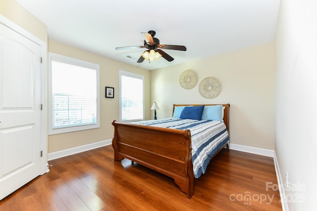 bedroom with ceiling fan and dark hardwood / wood-style floors