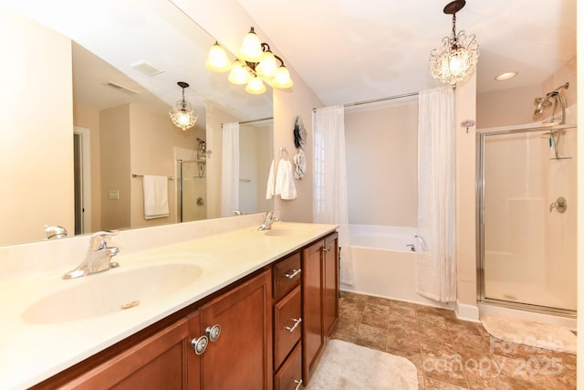 bathroom featuring vanity and independent shower and bath