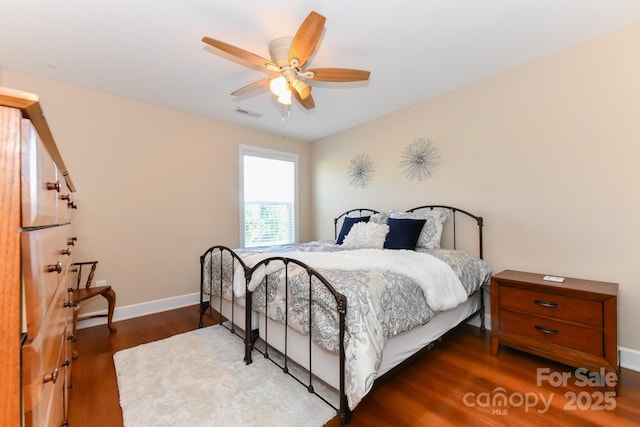 bedroom with ceiling fan and dark hardwood / wood-style flooring