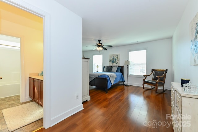 bedroom featuring ensuite bath, ceiling fan, and dark wood-type flooring