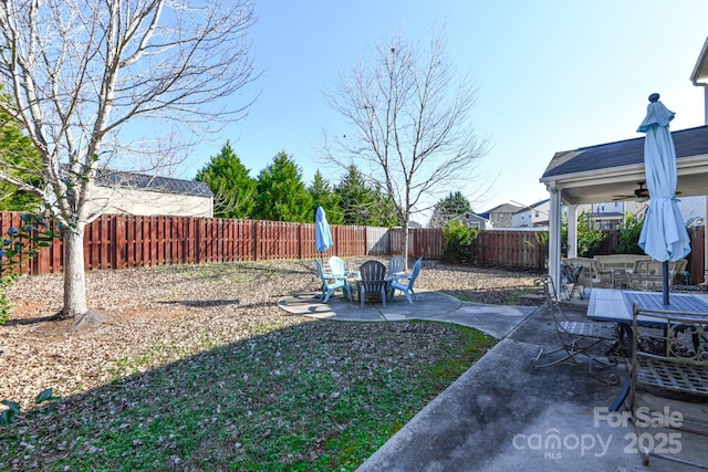 view of yard with ceiling fan and a patio area