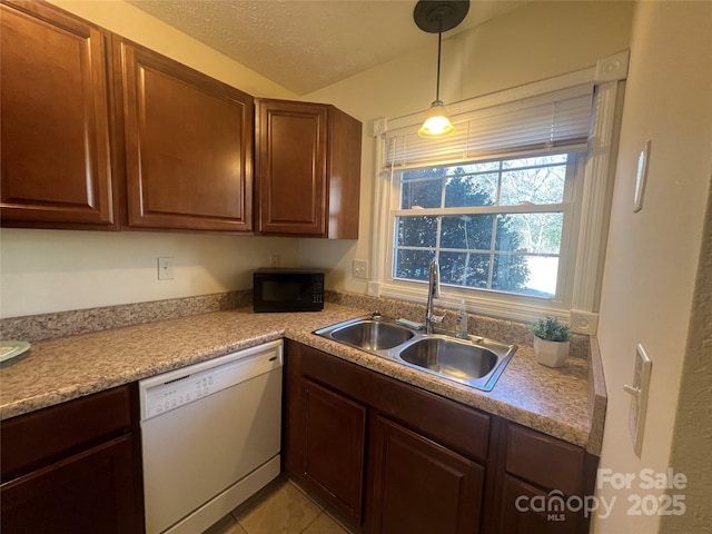 kitchen with white dishwasher, sink, decorative light fixtures, lofted ceiling, and light tile patterned flooring