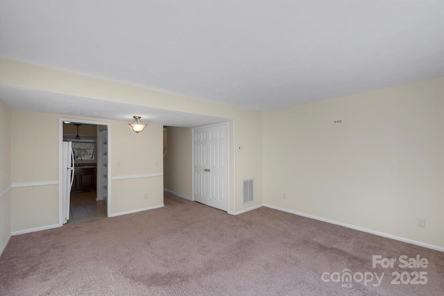 spare room with light colored carpet