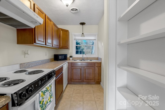 kitchen featuring light tile patterned flooring, sink, hanging light fixtures, a textured ceiling, and white appliances