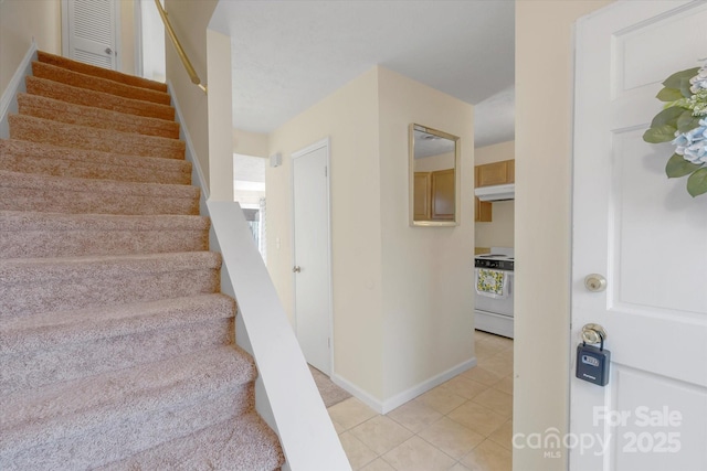 stairs with tile patterned flooring