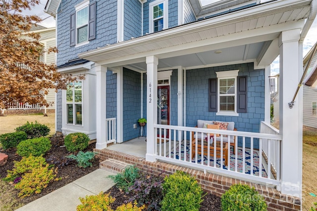 view of exterior entry with a porch