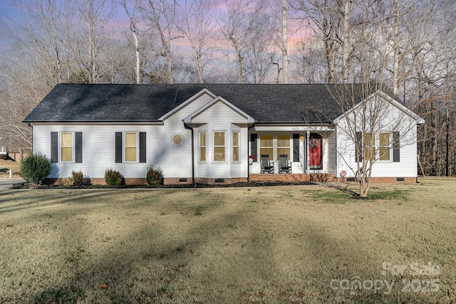 ranch-style home featuring a lawn and a porch