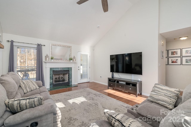 living room with ceiling fan, high vaulted ceiling, and wood-type flooring