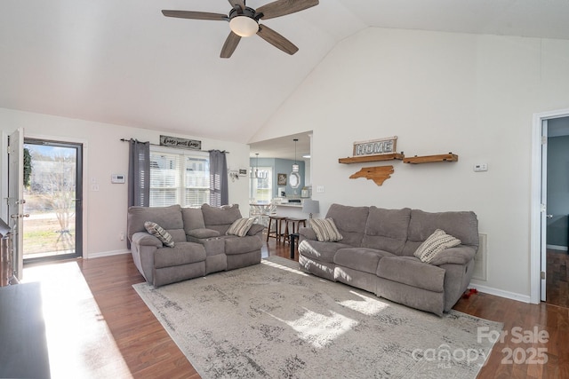 living room featuring ceiling fan, vaulted ceiling, and hardwood / wood-style flooring