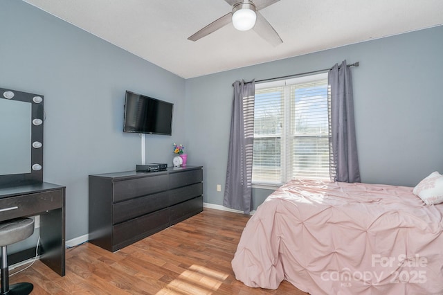 bedroom with multiple windows, light wood-type flooring, and ceiling fan