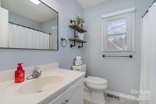 bathroom with tile patterned floors, vanity, and toilet