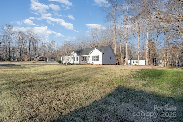 exterior space with a shed and a front lawn