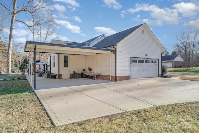 view of property exterior with a garage, a carport, and cooling unit