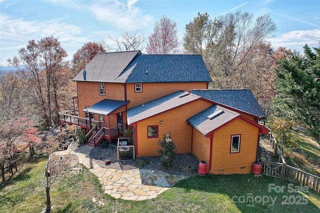 back of property featuring a yard and a wooden deck